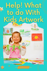 Little girl holding a craft with artwork on the wall behind her. What to do with kid's artwork pinnable image.
