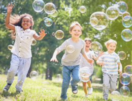 Kids chasing bubbles for feature image