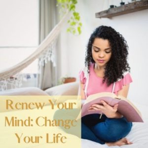 Renew your mind feature image of woman sitting on her bed reading her Bible