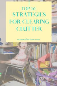 Clearing Clutter pinnable image of toddler sitting on chair in a cluttered room
