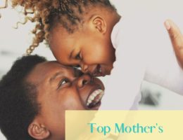 Mother's love Bible verses feature image of a smiling woman holding up her toddler.