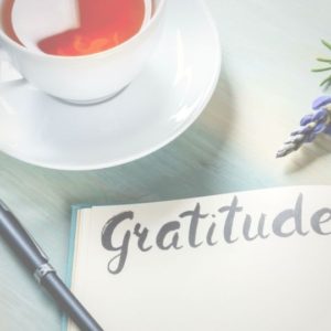 Gratitude Challenge feature image of "Gratitude" in calligraphy on a journal by a cup of tea