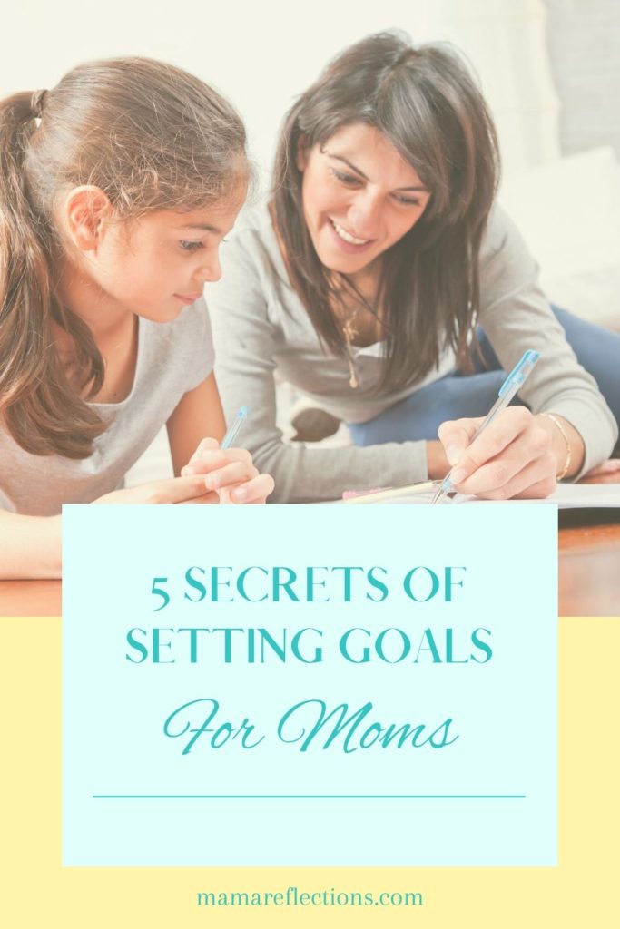 mom working on a project with daughter pinterest image for Goal settings for moms