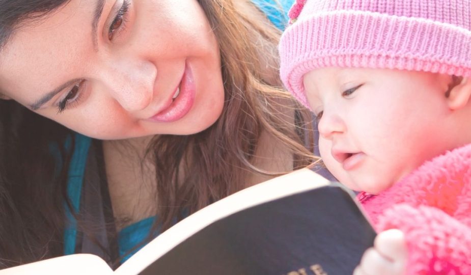 Biblical Motherhood feature image of a mom reading a Bible with her toddler girl